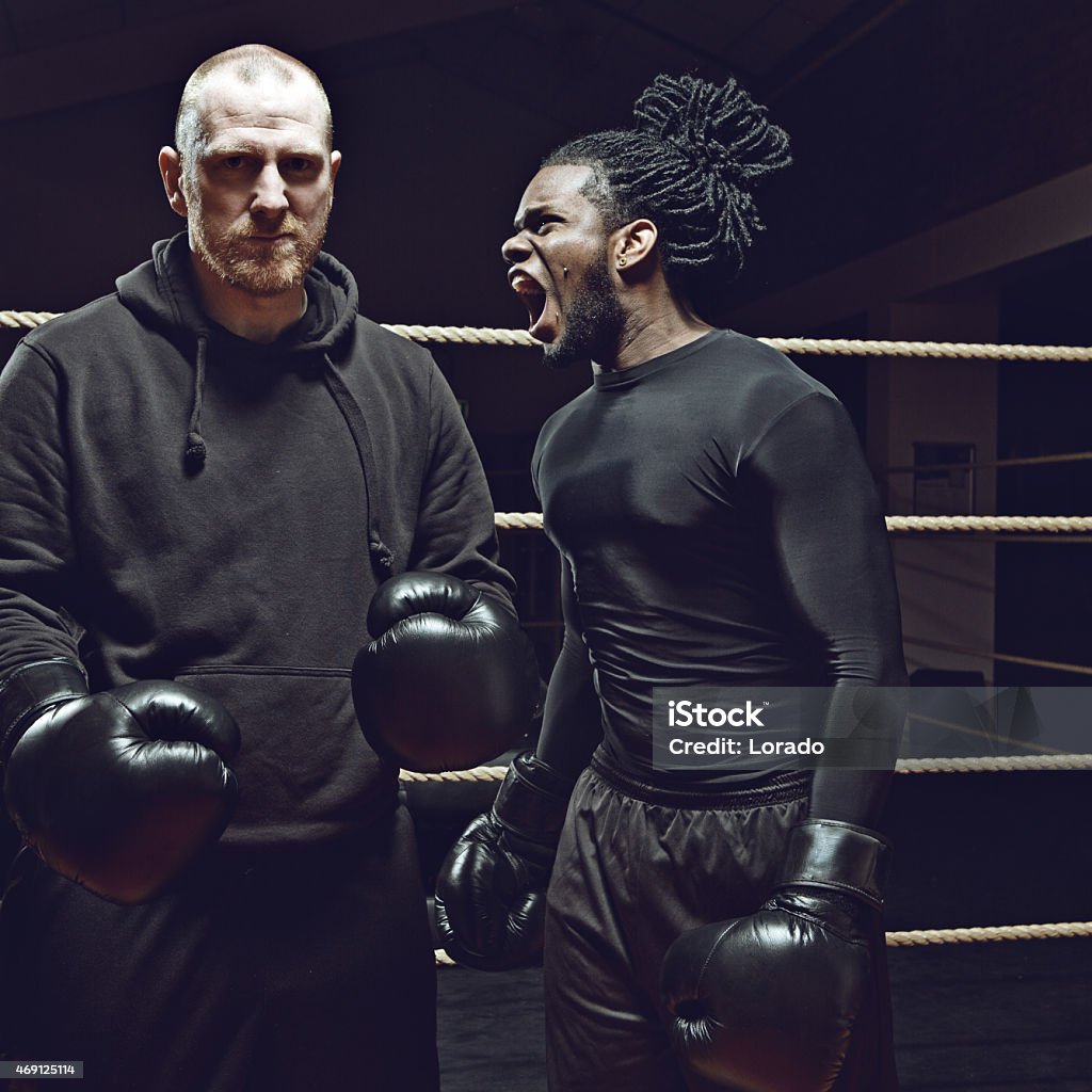 angry black boxer shouting at his opponent Coach Stock Photo