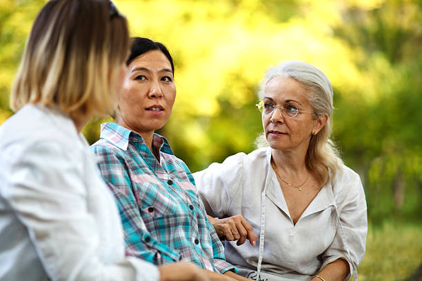 istock Three women having a serious discussion at a park 469133949