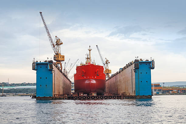 istock Floating blue dry dock with red tanker under repair 469139732