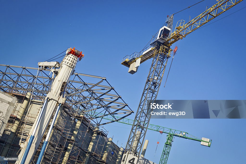 Cranes and steel roof structure against blue sky Blue Stock Photo