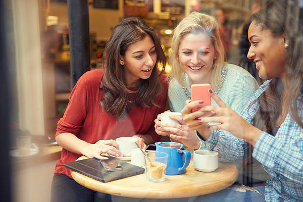 istock Group Of Female Friends In Caf Using Digital Devices 469140116