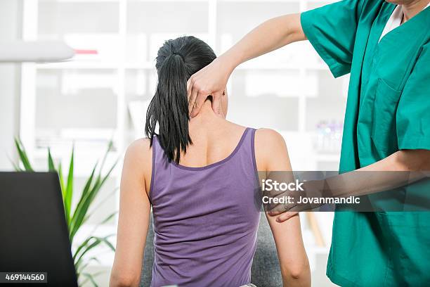 Chiropractor Stretches Female Patient Neck Muscles Stock Photo - Download Image Now - Physical Therapy, Chiropractic Adjustment, Chiropractor