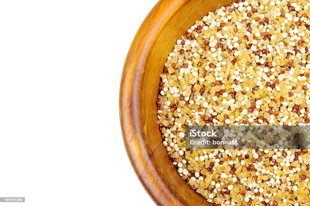 Quinoa bulgur mix in a wooden bowl isolated on white 2015 Stock Photo