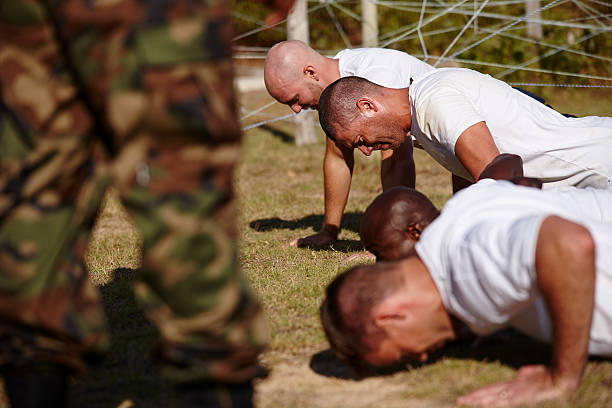 You've gotta push through the pain Shot of a group of men doing push-ups at a military bootcamphttp://195.154.178.81/DATA/i_collage/pu/models/3701.jpg military camp stock pictures, royalty-free photos & images
