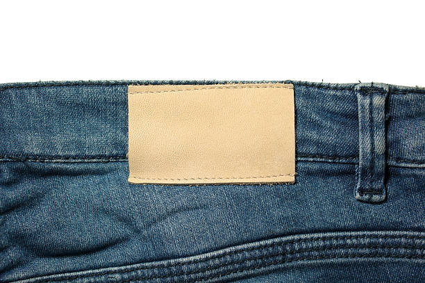 weißes leder-label auf jeans, isoliert auf weiss - leather patch denim jeans stock-fotos und bilder