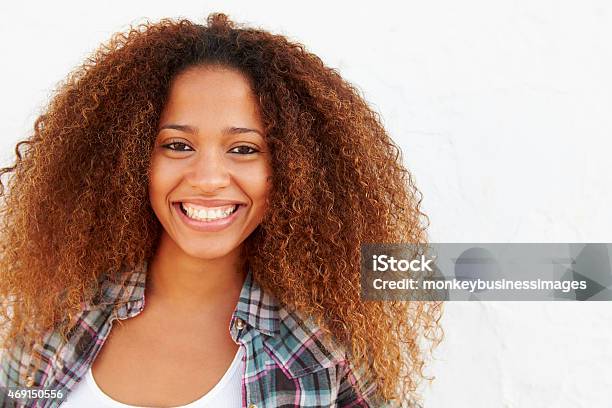 Portrait Of Woman Standing Outdoors Against White Wall Stock Photo - Download Image Now