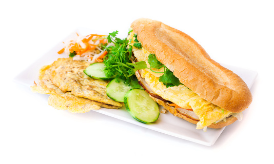 Banh mi ¬ vietnamese baguettes sandwiches  on white background. Banh mi - white baguettes prepared with eggs. Decorated with fresh coriander.