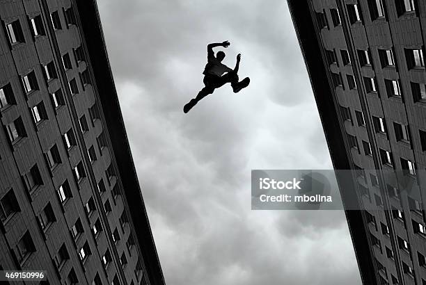 Man Jumping Over Building Stock Photo - Download Image Now - Free Running, Jumping, Stunt Person