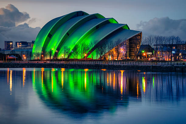 SECC, Glasgow Glasgow, UK - February 6, 2014: The Scottish Exhibition and Conference Centre in Glasgow, on the River Clyde.  Commonly known as the Armadillo. Lit up in green at night. glasgow scotland stock pictures, royalty-free photos & images