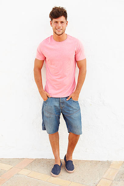istock Portrait Of Young Man Standing Outdoors Against White Wall 469155172