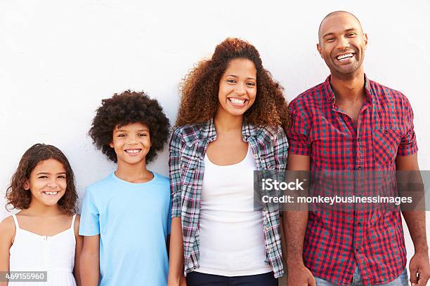 Family Standing Outdoors Against White Wall Stock Photo - Download Image Now - 20-29 Years, 2015, 30-39 Years