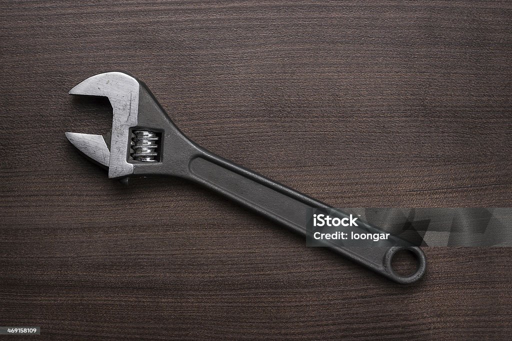 adjustable wrench on the wooden table adjustable wrench on the brown wooden table Adjustable Wrench Stock Photo