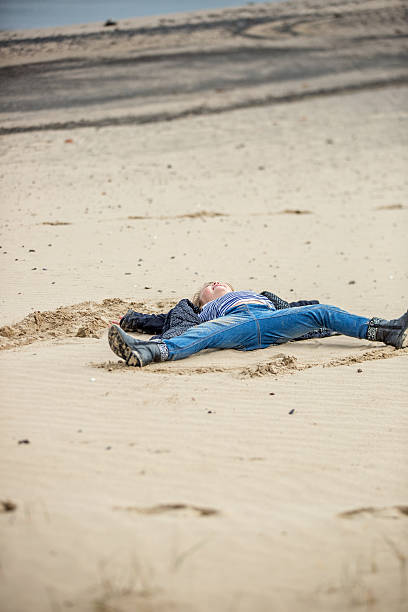 istock Six year old girl on beach lying on back 469159456