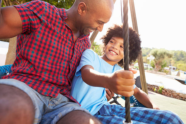 istock Father And Son Having Fun On Swing In Playground 469162780