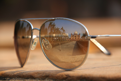 Tomb of Safdarjung reflected in sunglasses. Tomb was built in 1754 in the late Mughal Empire style in New Delhi, India