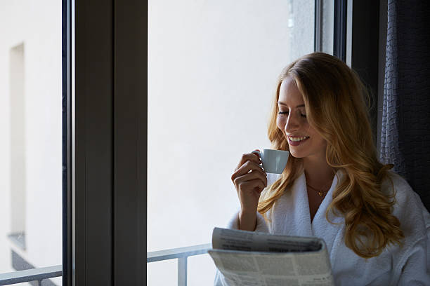 istock Young woman talking on the phone and drinking coffee 469163634