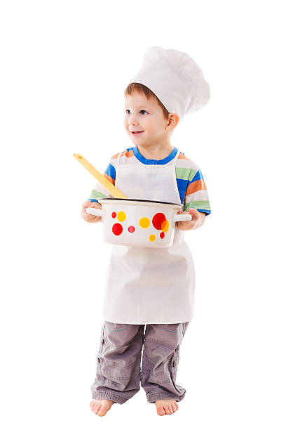 istock Little cook standing with ladle and pan 469165417