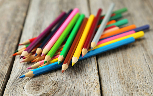 istock Colour pencils on grey wooden background 469168258