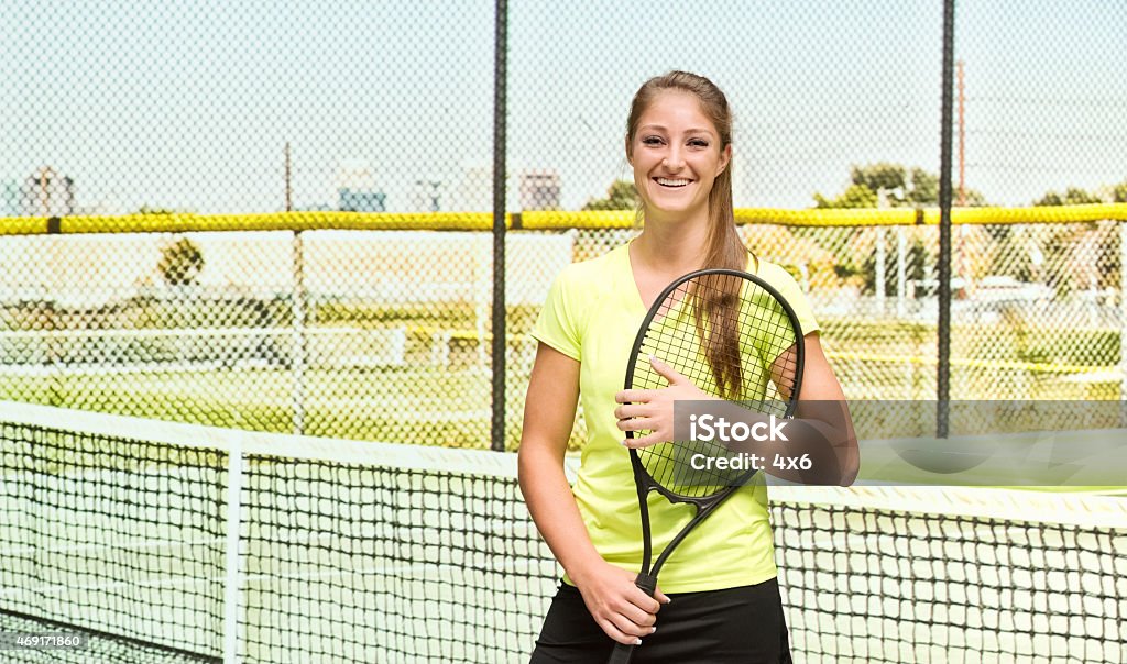 Cheerful female tennis player in court Cheerful female tennis player in courthttp://www.twodozendesign.info/i/1.png 20-24 Years Stock Photo