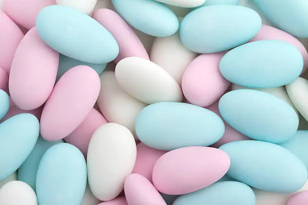 background of sugared almonds color blue, rose and white