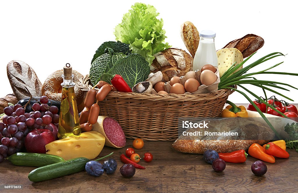 Large variety of food studio photography of wicker basket with goods on old wooden table Abundance Stock Photo