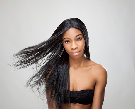 Beautiful young black woman with long straight hair