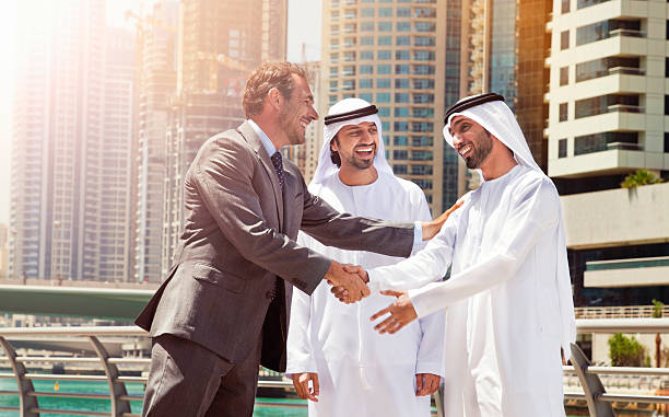 Businessmen struck a deal in Dubai. stock photo