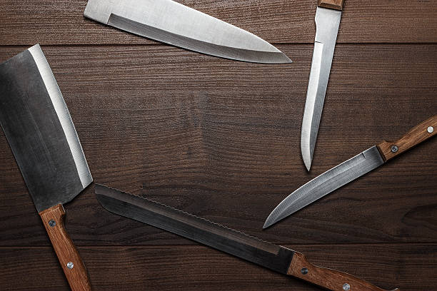 istock kitchen knifes on brown wooden table background 469175111