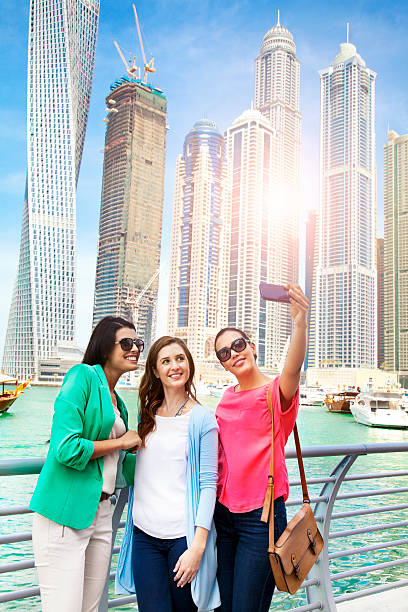 istock Three friends taking selfie photo in Dubai 469177628