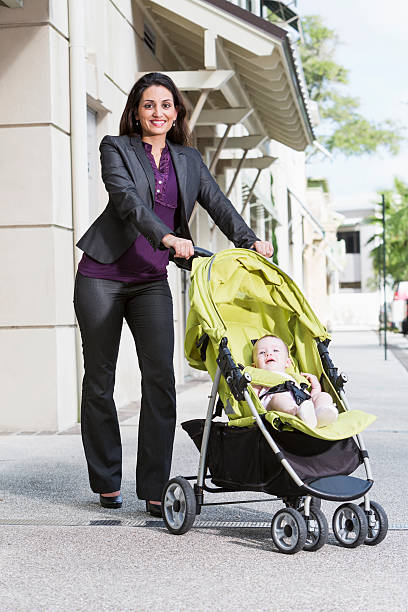 istock Business woman pushing baby stroller 469182397