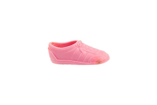 A pink and white tennis shoe with shadow isolated on white.