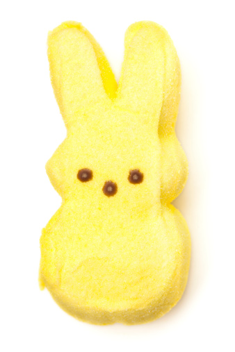 Belen, New Mexico, USA - April 5, 2012: One yellow Peeps Marshmallow Bunny on a white background. Peeps Brand marshmallow candies are a combination of sweet colored sugar and fluffy marshmallow. Peeps are made by Just Born, Inc. of Bethlehem, PA, a family-owned candy manufacturer.