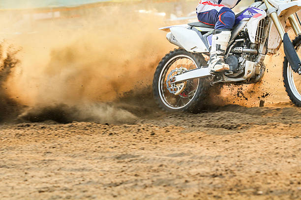 Motocross racer accelerating speed in track