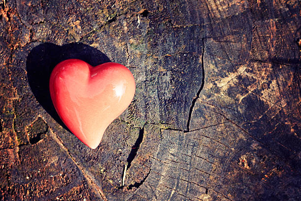istock greeting-card background red heart on wood 469190392