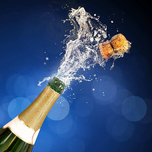 Champagne Popping Bottle A champagne bottle popping open. Celebrations. club soda stock pictures, royalty-free photos & images