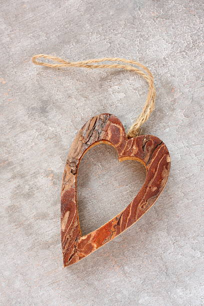 istock Heart made from tree bark on wooden background 469194881