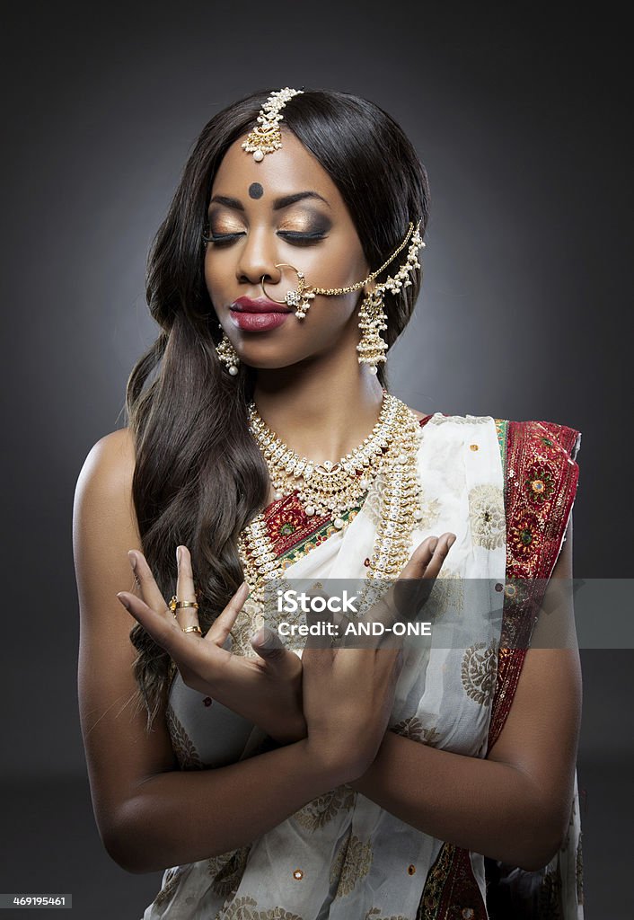 Indian woman in traditional clothing with bridal makeup and jewelry Young Indian woman dressed in traditional clothing with bridal makeup and jewelry Adult Stock Photo