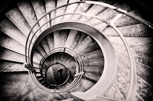 Walking woman in center of spiral stairs