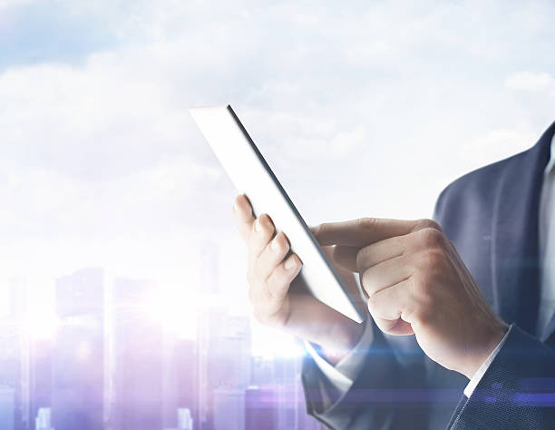 istock Businessman with digital tablet on blurred city background 469195924
