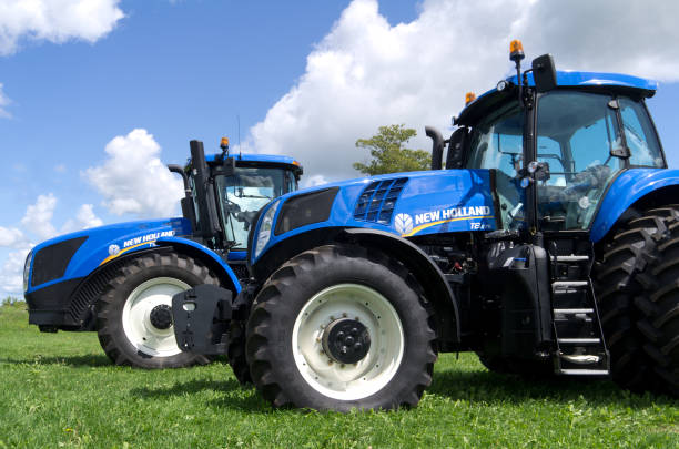 Chesley, Ontario, Canada - August 18, 2012: New Holland is a full range manufacturer of agricultural machinery. New Holland agricultural products include tractors, combine harvesters, balers, haying tools, equipment used in lawn, grounds and turf care, grape harvesters. The company was founded in 1895 in New Holland, Pennsylvania; it was acquired by Ford in 1986 and by Fiat in 1991, becoming a full line producer. Since 1999, New Holland is a Brand of CNH and part of Fiat Industrial.