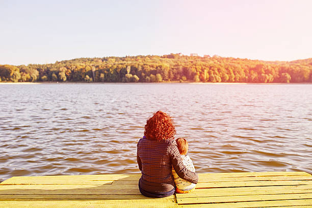 istock Mom and son resting by the lake 469197508