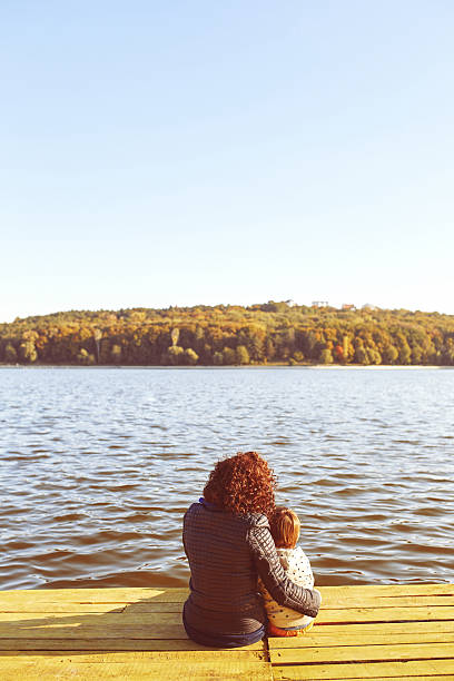 istock Mom and son resting by the lake 469197510