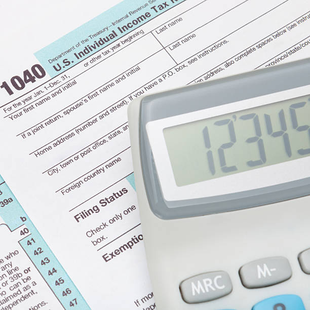 istock Calculator over US 1040 Tax Form 469197548