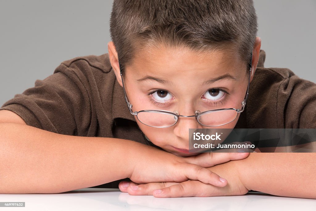 Serious child (real people) Serious caucasian boy on gray background 2015 Stock Photo