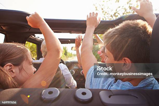 Grandparents Taking Grandchildren On Trip In Open Top Car Stock Photo - Download Image Now