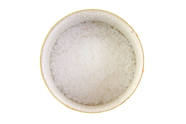 istock Sea salt in a cup on white background 469200010