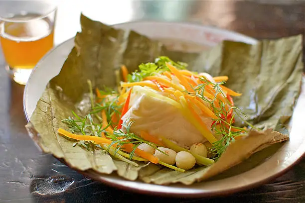 Typical South East Asian Fish combined with vegetables, served on a lotus leaf. 
