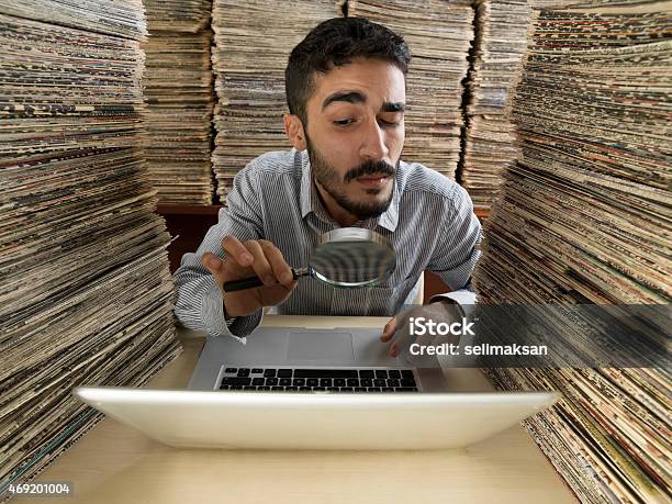 Adult Man With Dark Hair Doing Research In Media Archive Stock Photo - Download Image Now
