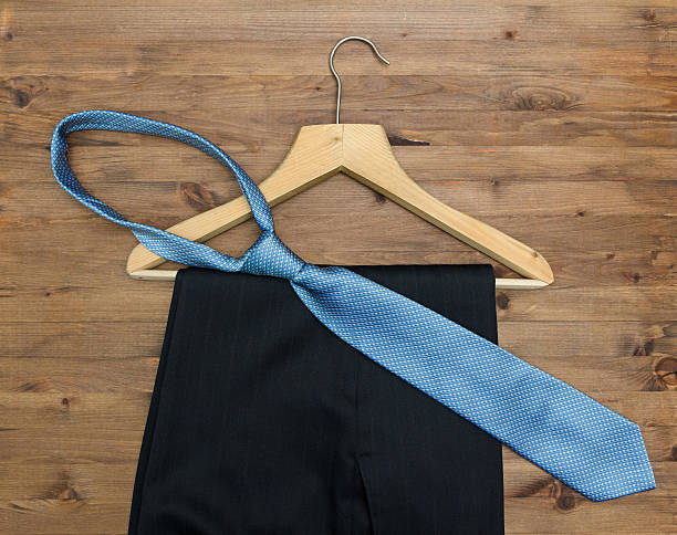 istock wooden hanger with  tie and trousers 469201518