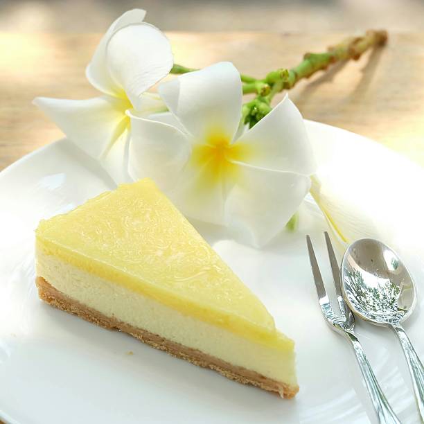 Lemon cheese pie decorated with Frangipani flowers on white plate